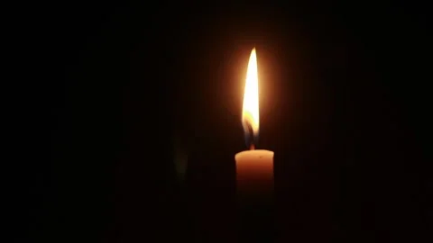 Loopable flickering candle flame against a dark background 動画素材 332851704