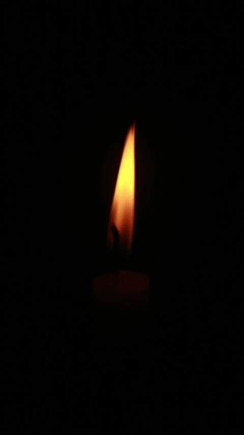 Loopable flickering candle flame against a dark background 動画素材 332851777