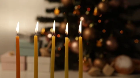 Loopable - Hanukkah candles burning in front of Cristmas tree Stock Footage 121384680