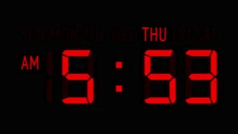 Loopable: Red LED Digital Clock Displays Current Time at Thursday in 12-Hours Stock Footage 163212772