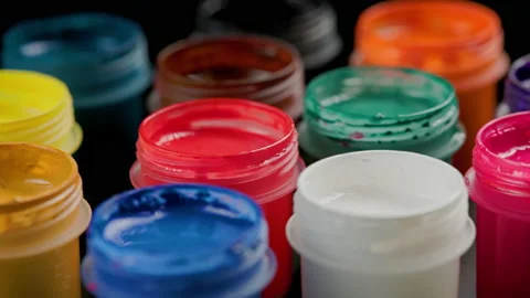Loopable rotating close-up background of opened small gouache paint jars Stock Footage 182006714