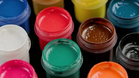 Loopable rotating close-up background of opened small gouache paint jars Stock Footage 182986048