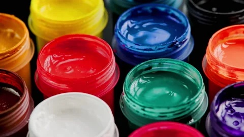 Loopable rotating close-up background of opened small gouache paint jars Stock Footage 183935444