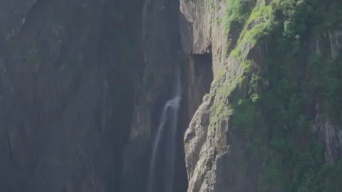 Loopable Tranquil Isolated Waterfall in Gargantuan Mountainous Landscape Stock Footage 314937042
