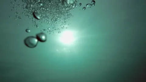 Loopable Underwater Scene with Sun Rays and Rising Air Bubbles in a Lake Video stock 311773491