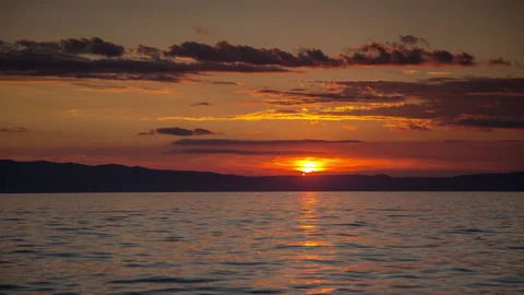 Loopable video of clouds moving in sky at sunset over Mediterranean sea Stock Footage 132633523