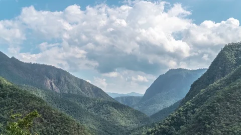 Loopable Video Timelapse of Clouds Moving above Mountain Valley on Sunny Day Stock Footage 100830745