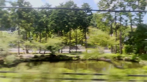 Loopable video of a view from a train window in Japan of a passing train Stock Footage 160708536