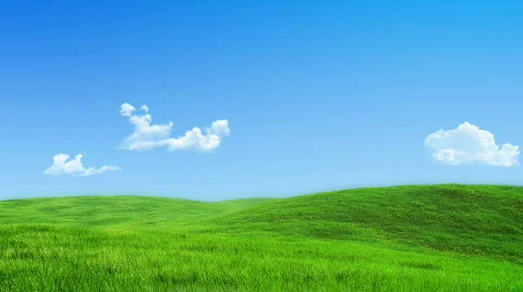  Looped 30 sec clouds over green meadow Stock Footage 714041