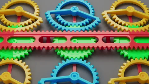 Looped animation of a group of multi-colored children plastic gears. Stock Footage 273924384
