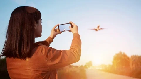 Looped cinematograph of hand holding smartphone while recording video of landing Stock Footage