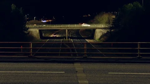 Looped Night time traffic time lapse at motorway roundabout with traffic lights. 動画素材 72669832