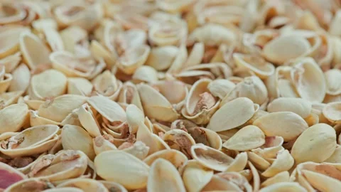 Looped rotating empty pistachios shells full frame close-up background Video stock 164246375