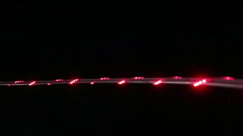 Looping abstract background with blurred white and red lights on black backdrop Stock Footage 341410107