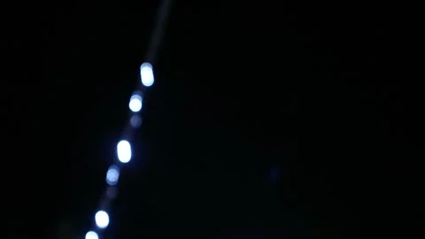 Looping abstract background with blurred white and red lights on black backdrop Stock Footage 341410467