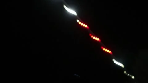 Looping abstract background with blurred white and red lights on black backdrop Stock Footage 341410470