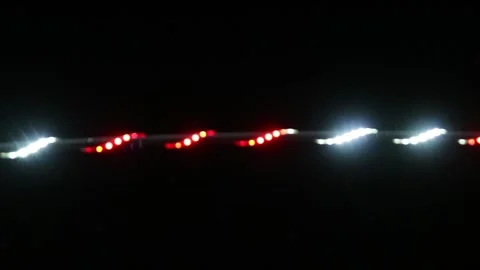 Looping abstract background with blurred white and red lights on black backdrop Stock Footage 341410655