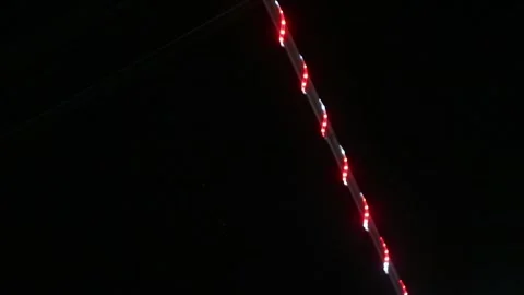 Looping abstract background with blurred white and red lights on black backdrop Stock Footage 341410658