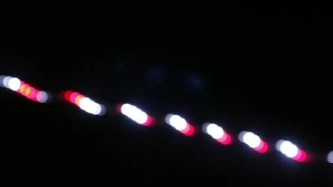 Looping abstract background with blurred white and red lights on black backdrop Stock Footage 341410824