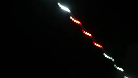 Looping abstract background with blurred white and red lights on black backdrop Stock Footage 341410831