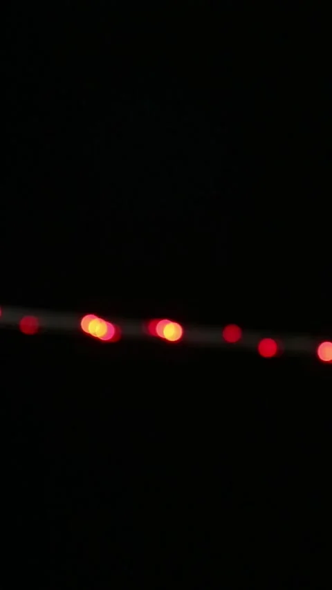 Looping abstract background with blurred white and red lights on black backdrop Stock Footage 341441785