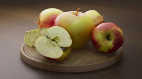 Looping animation around a composition of apples lying on a wooden board. Stock Footage 308738162