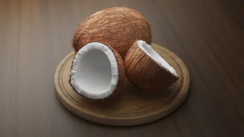 Looping animation around a composition of coconuts lying on a wooden board. Stock Footage 308738669