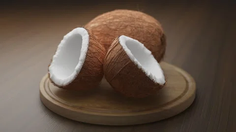 Looping animation around a composition of coconuts lying on a wooden board. Stock Footage 309334064