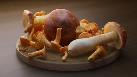 Looping animation around a composition of mushrooms lying on a wooden board. Stock Footage 310795076