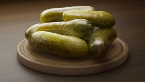 Looping animation around a composition of pickles lying on a wooden board. Stock Footage 310793533