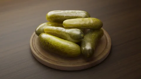 Looping animation around a composition of pickles lying on a wooden board. Stock Footage 315522643
