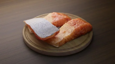 Looping animation around a composition of salmon lying on a wooden board. Video stock 312578010