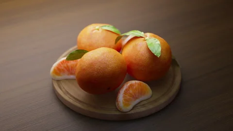 Looping animation around a composition of tangerines lying on a wooden board. Stock Footage 314045459