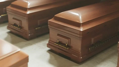 Looping animation of countless coffins standing on the floor before a funeral. Stock Footage 158240736