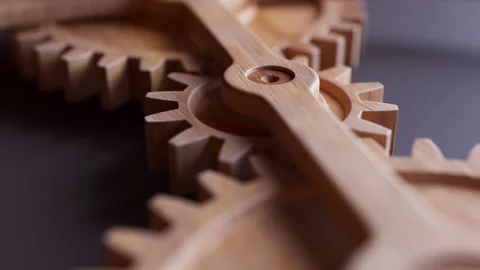 Looping animation of a mechanical construction made of wooden gears. Video stock 312576711