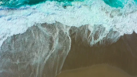 Looping background overhead turquoise waves crashing on beach Stock Footage 106636794