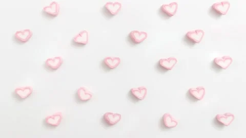 Looping footage pattern heart shape marshmallow pop up on white background. Stock Footage 264025161