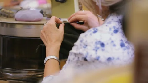 Looping machine operator working in a knitwear factory - worker hands Stock Footage 103729335