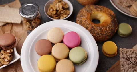 Looping macro of macarons with bagel and walnuts, cozy dessert still life Stock Footage 320170915