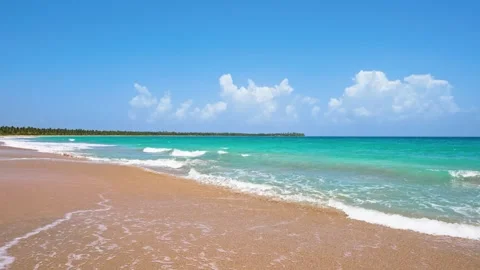 A looping ocean texture, a view of calm ocean waves. Sea waves on golden sand. Stock Footage 328645640