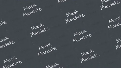 Looping scrolling mask mandate written in white chalk on a black chalkboard Stock Footage 158861220