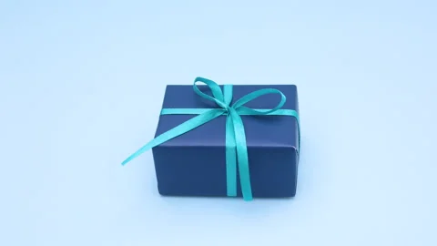 Looping stop motion animation of blue gift moving on blue theme Stock Footage 137357594