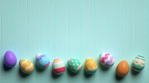 Looping video of painted easter eggs on a wooden blue table animated in sto.. Video stock 303635306