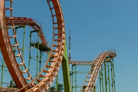 Loops of a roller coaster on blue sky background with copyspace Stock Photos
