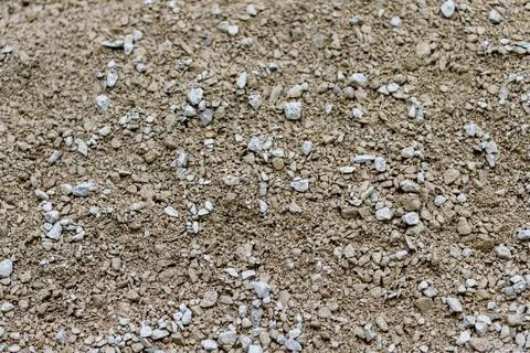 Loose aggregate material with brown pebbles and white gravel Stock Photos