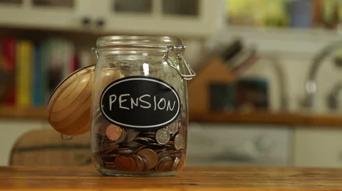 Loose change put in a saving jar, reading Pension Stock Footage 44116919