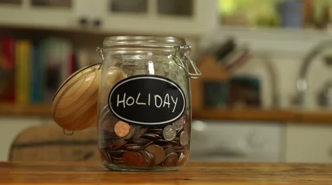 Loose change put in a saving jar, reading Holiday Stock Footage 44116924