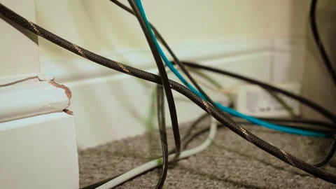 Loose computer cables scattered behind desk and across carpet floor. Ethernet Stock Footage 337642206