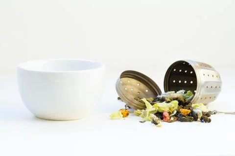 Loose herbal tea in tea strainer Stock Photos