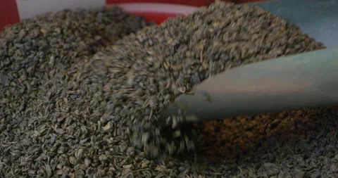 Loose leaf tea being scooped with metal scoop in market container Stock Footage 332432967